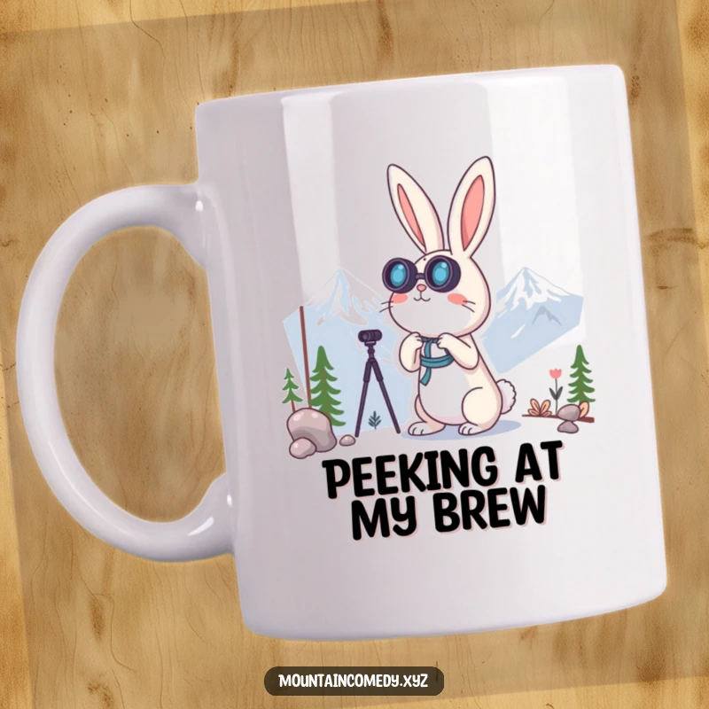 Funny rabbit character peering through binoculars at distant mountain peaks, symbolizing curiosity and exploration on this charming mug.
