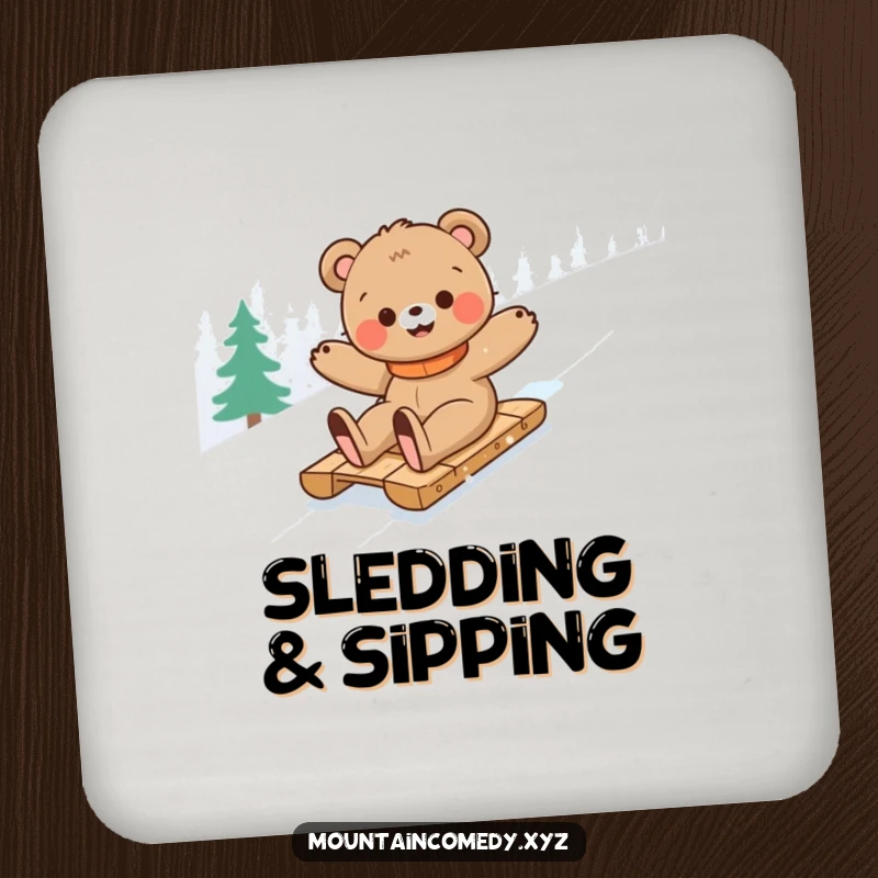 Funny bear cub character sledding down a snowy mountain, featured on this set of humorous drink coasters for table protection.