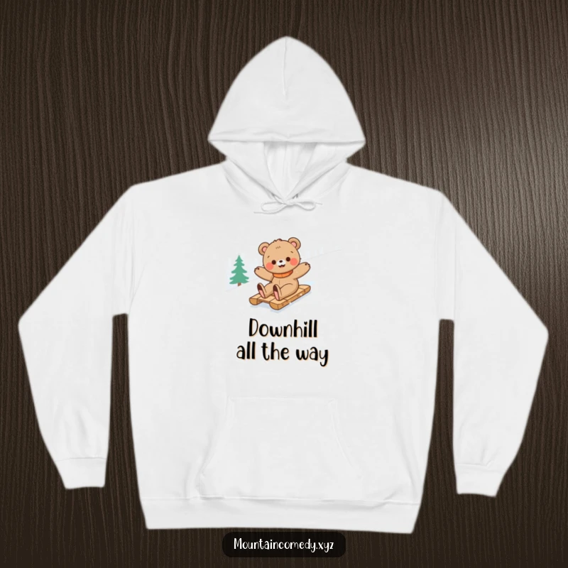 Funny bear cub character enjoying a thrilling slide down a snowy mountain on a sled, captured on a cozy and hilarious hoodie.