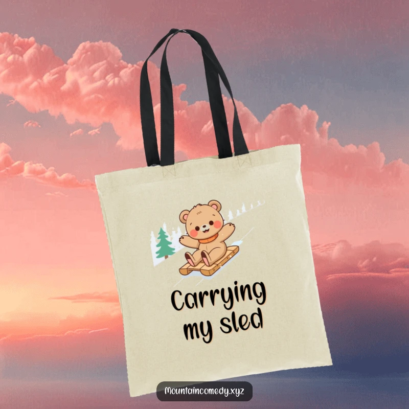 Funny bear cub character speeding down a snowy mountain on a makeshift sled, depicted on a durable and humorous tote bag.